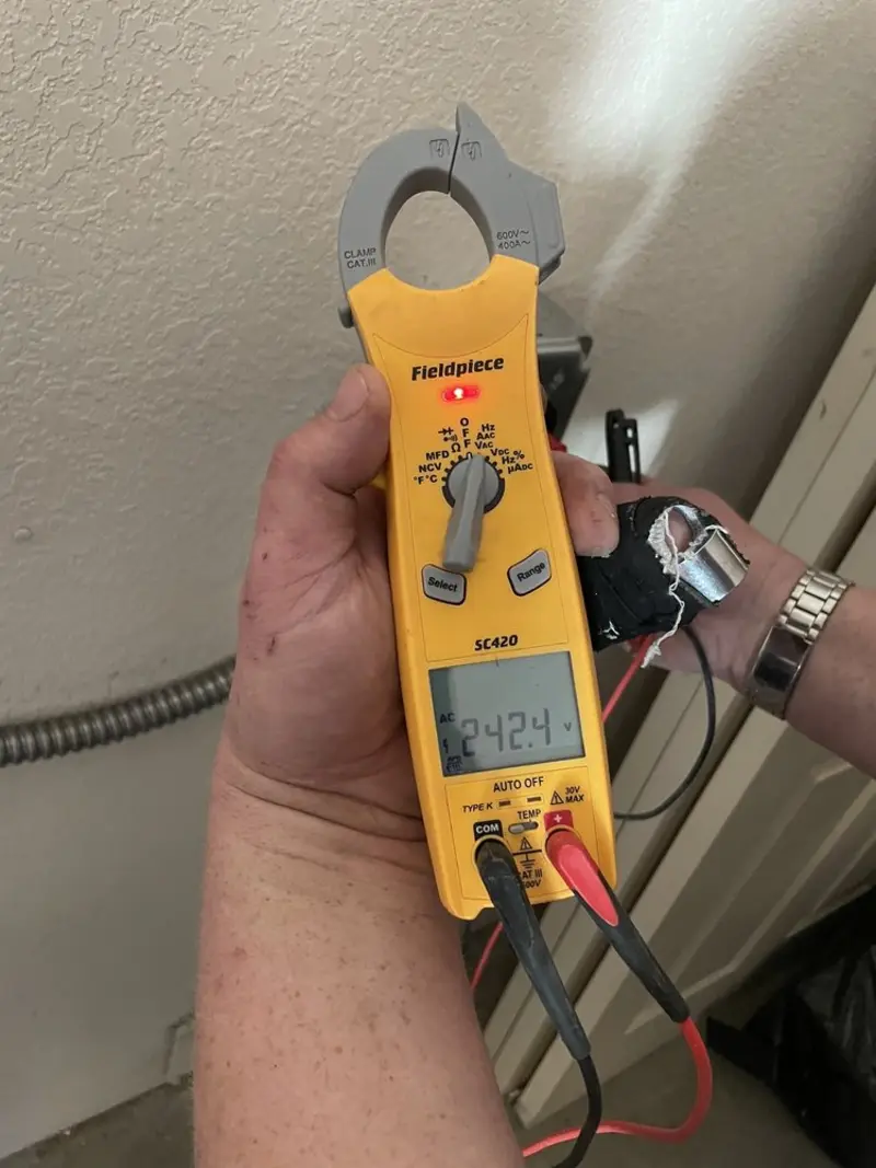 Voltage testing with clamp meter during Whole House Surge Protector in West Lafayette